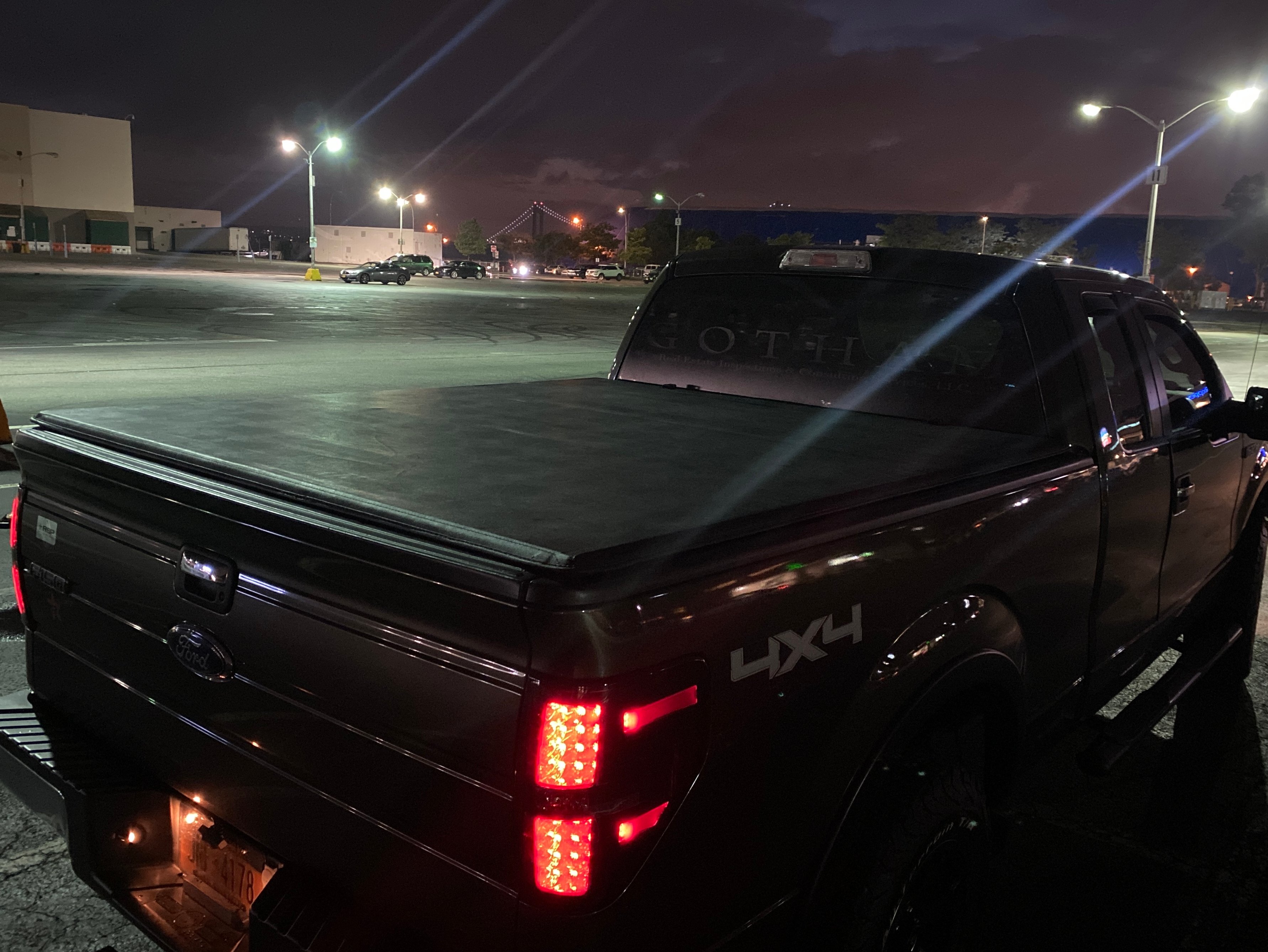 Ford F-150 with a soft tri-fold tonneau cover closed over the truck bed, featuring a low-profile vinyl design for cargo protection.