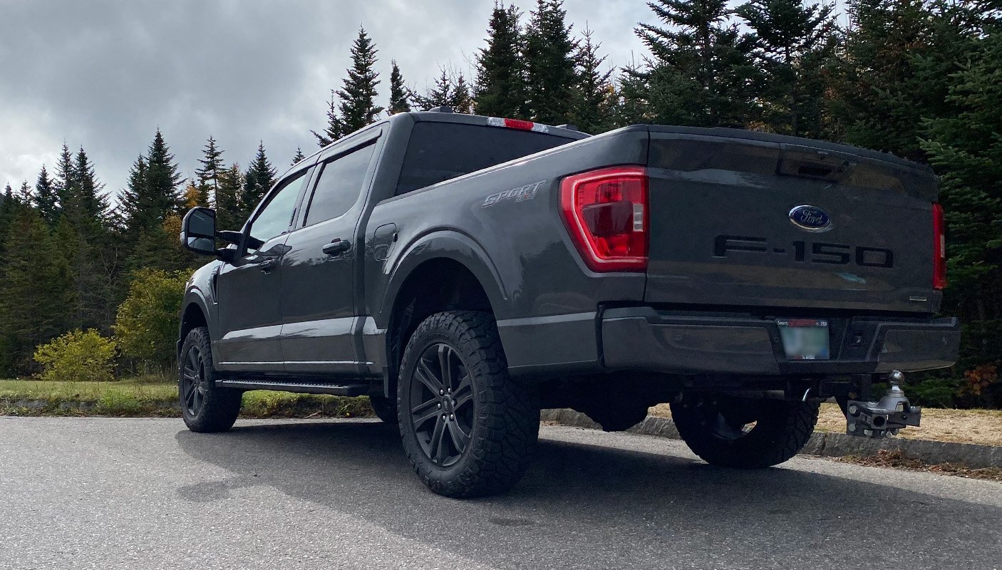 Gray F-150 with tonneau cover driving on highway