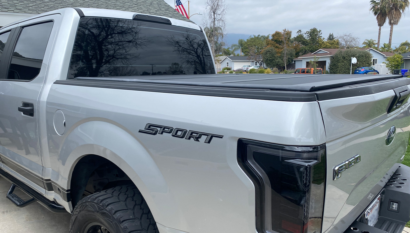 Silver F-150 sport with tonneau cover