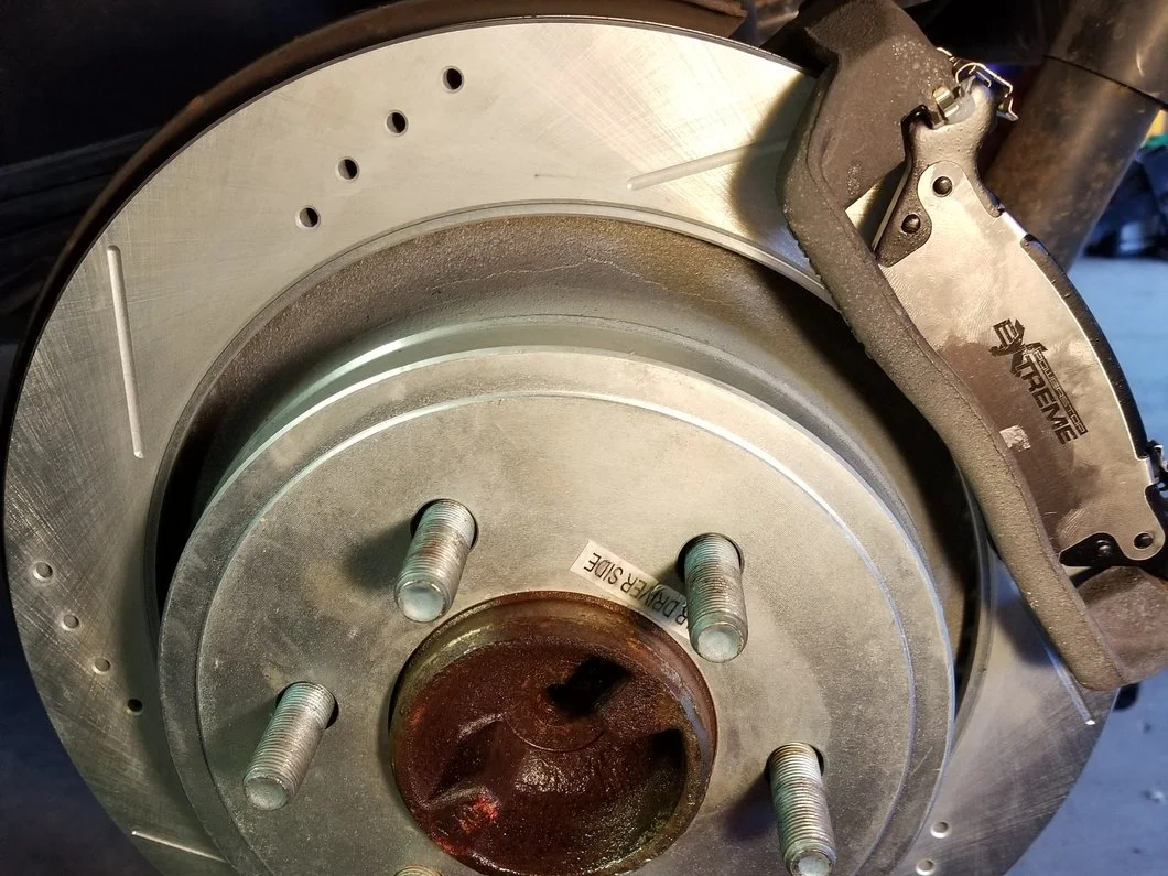 Close-up of a truck wheel hub with a five-lug bolt pattern exposed after wheel removal, showing the wheel studs and brake rotor.