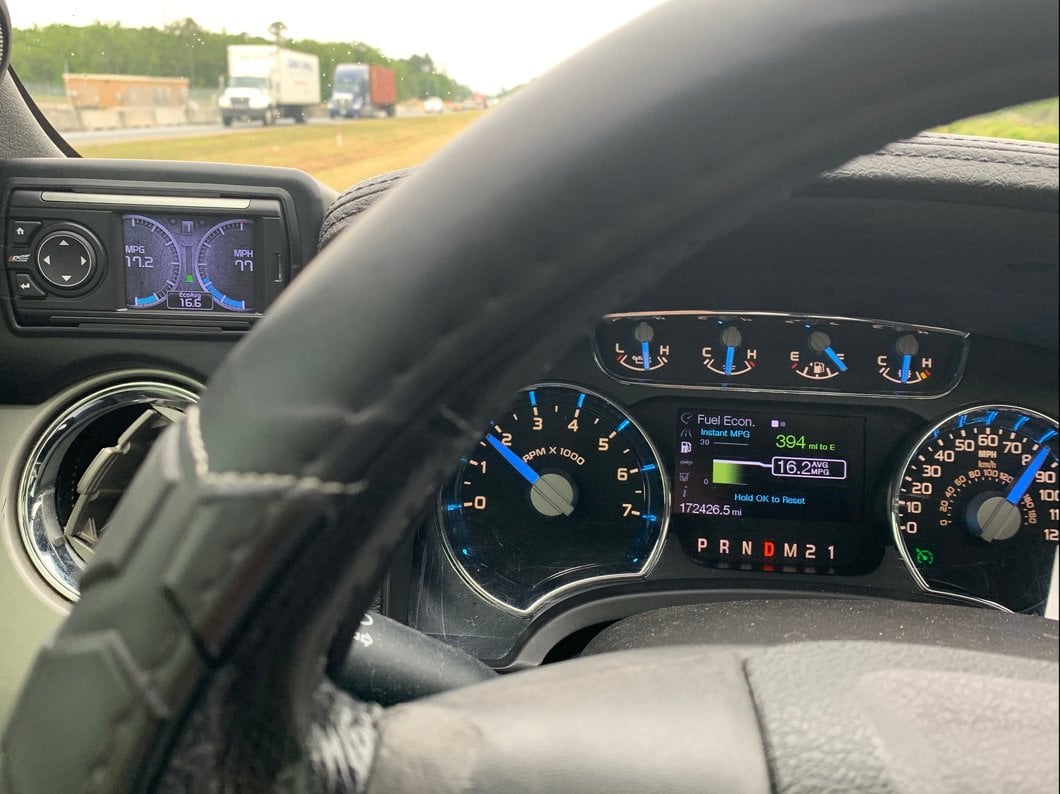 Edge Evolution performance tuner mounted inside a Ford F-150, displaying real-time engine gauges and vehicle performance data on its color screen.