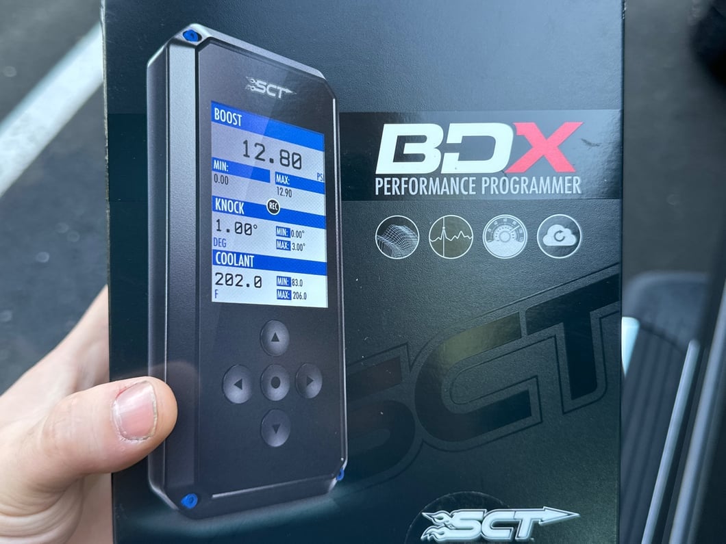 SCT BDX handheld performance programmer for a pickup truck, featuring a color display for custom tuning, diagnostic functions, and live engine data monitoring.