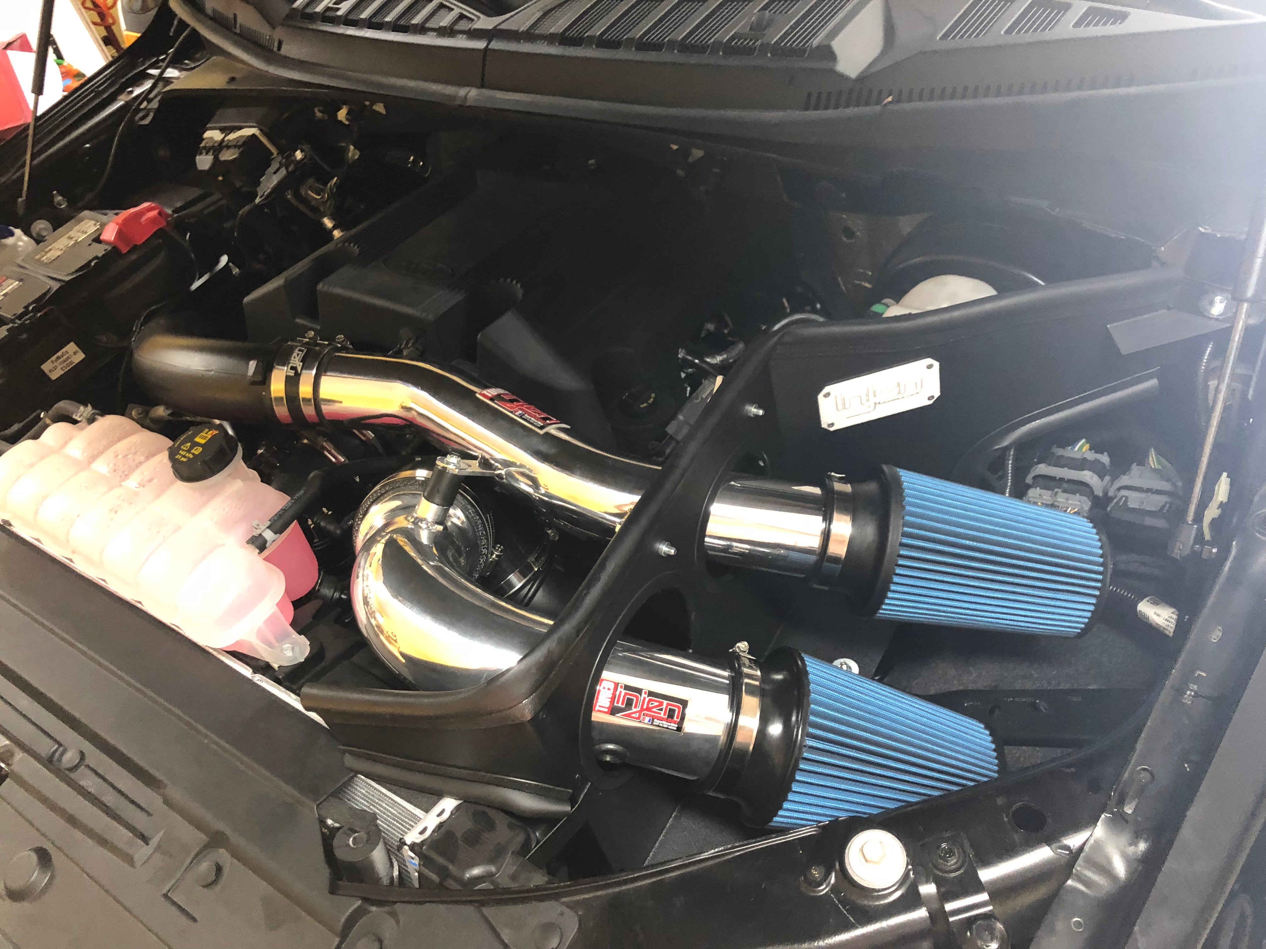 Injen cold air intake system installed on a truck engine